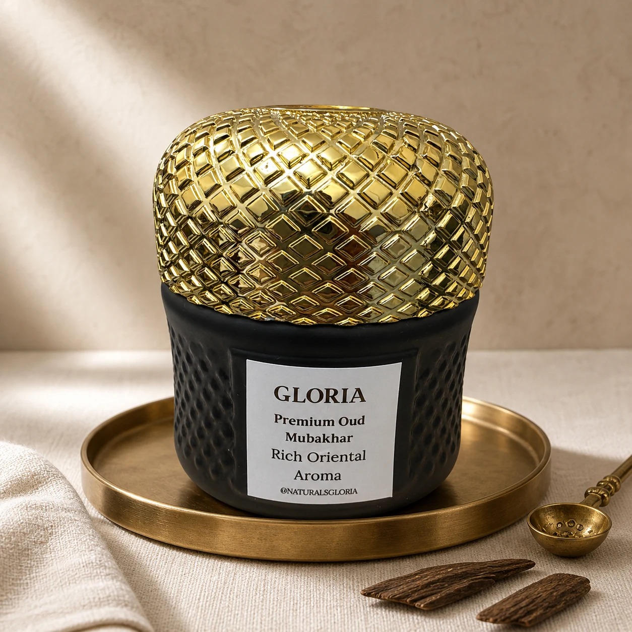 Premium Oud Mubakhar Bakhoor on a brass tray with a spoon and oud chips